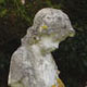 White marble cherub on hexagonal birdbath White marble cherub on hexagonal birdbath
