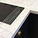 Honed Italian white marble, hob & splashback detail Honed Italian white marble, hob & splashback detail